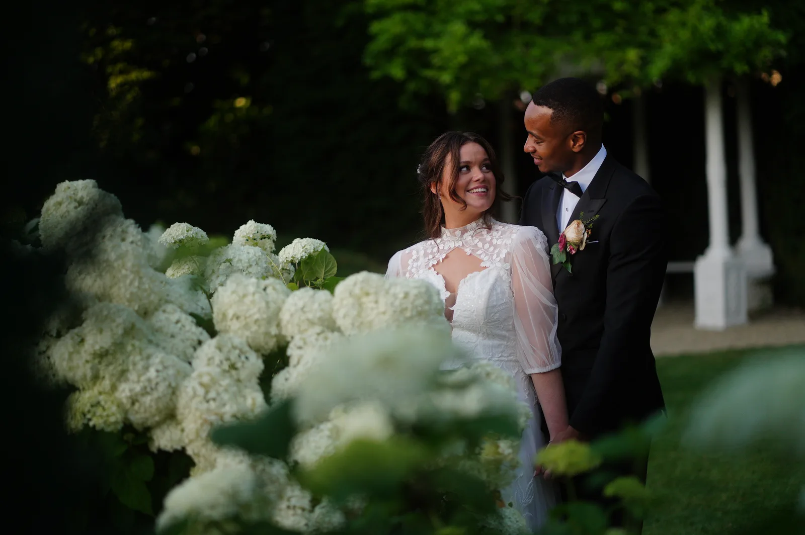 Bride and groom together in a country-house garden, a natural wedding film portrait