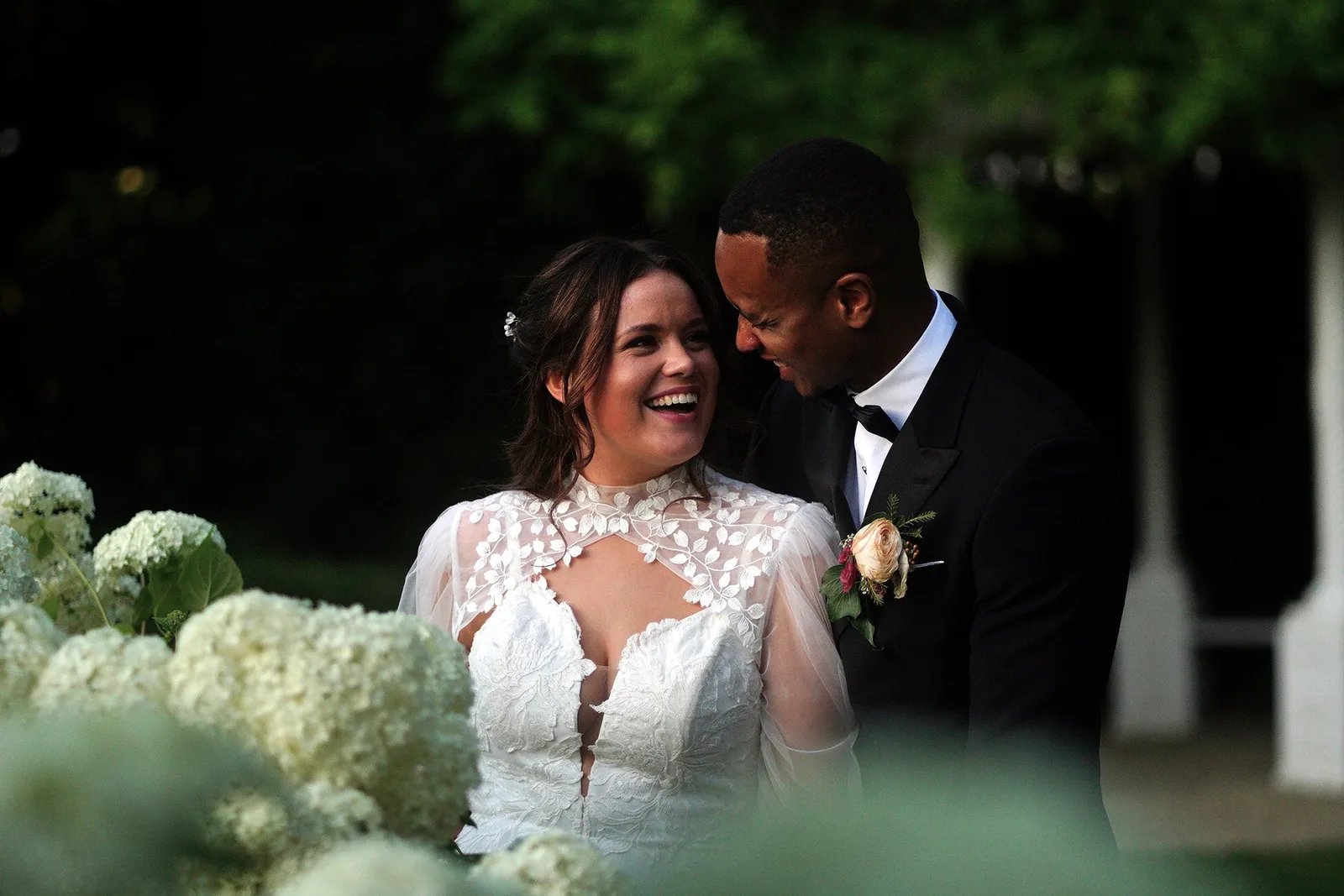 Bride and groom laughing together during a natural, unposed wedding moment