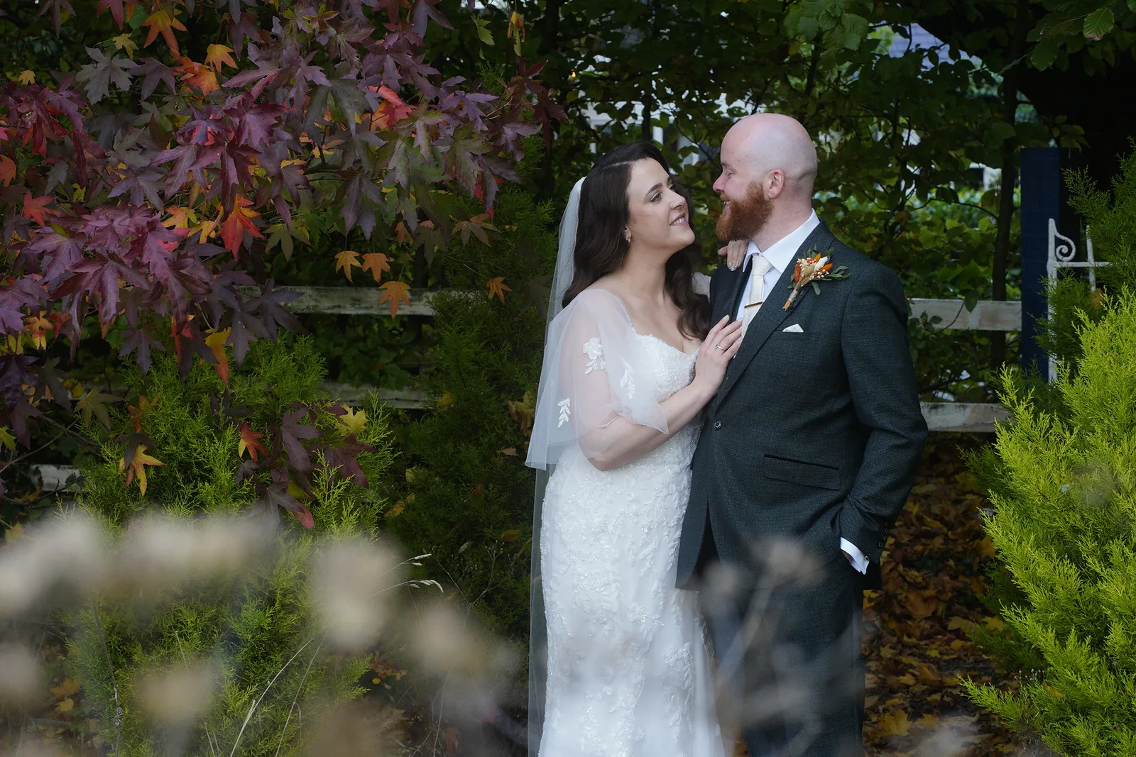 Bride and groom portrait among pink blossom