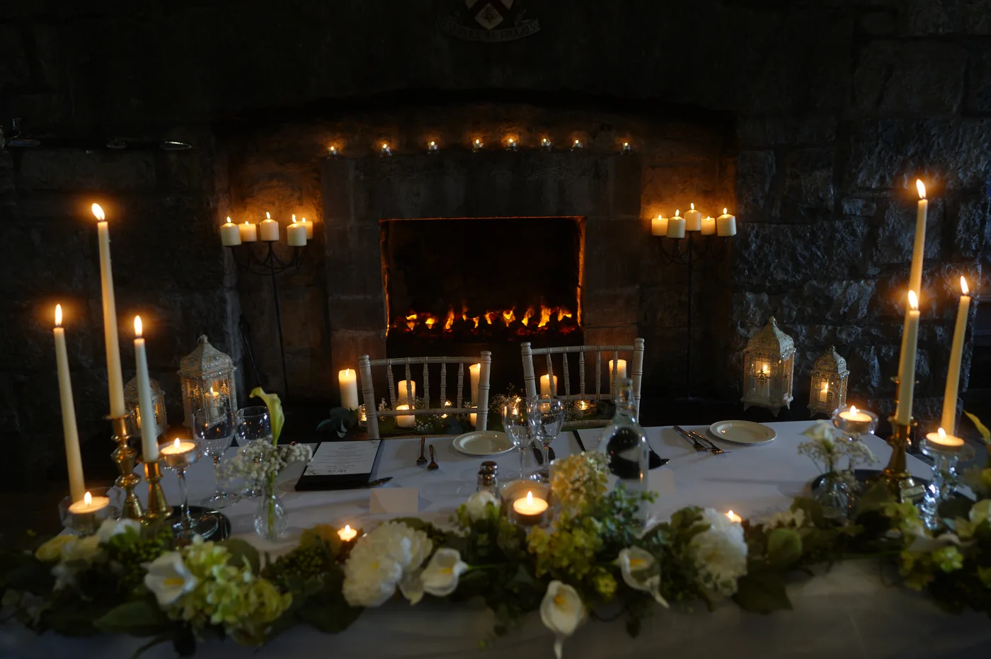 Candlelight and the fireplace in the banquet room at Cloughan Castle