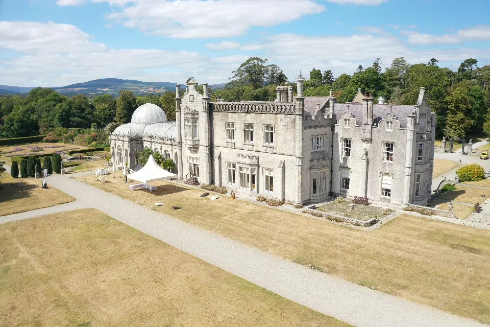 Killruddery House from the air, with the glass dome of the Orangery on the left and the Wicklow hills behind